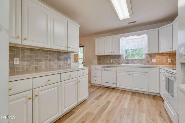 811 Fain Ave Unit 811, Kingsport, TN 37660 - kitchen featuring white appliances, light wood-type flooring, light countertops, decorative backsplash, and white cabinets