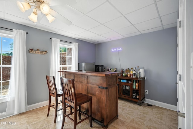 1251 Harmony Rd, Jonesborough, TN 37659 - bar area featuring a drop ceiling, freestanding refrigerator, and light tile patterned floors
