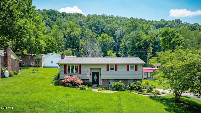 1049 Cooks Valley Rd, Kingsport, TN 37664 - raised ranch featuring a front yard, a chimney, and a wooded view