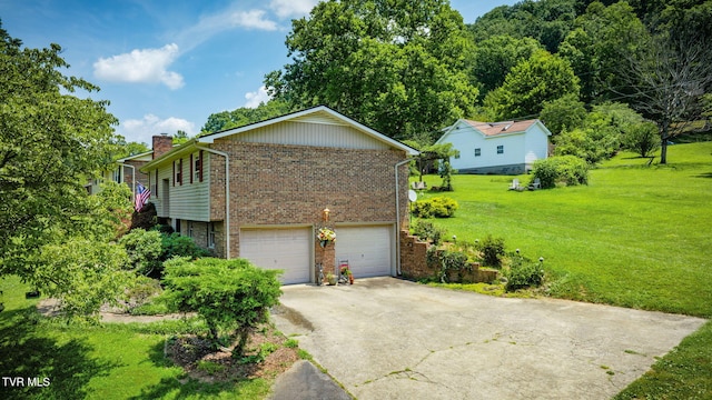 1049 Cooks Valley Rd, Kingsport, TN 37664 - view of side of property with brick siding, an attached garage, driveway, a chimney, and a yard