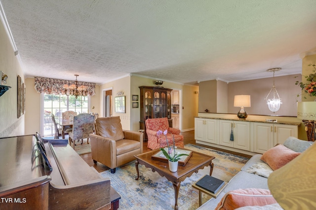 1049 Cooks Valley Rd, Kingsport, TN 37664 - living room featuring a chandelier, a textured ceiling, and crown molding