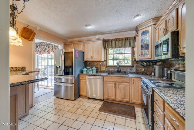 1049 Cooks Valley Rd, Kingsport, TN 37664 - kitchen featuring appliances with stainless steel finishes, light tile patterned flooring, decorative backsplash, a textured ceiling, and plenty of natural light
