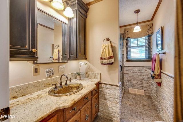 1049 Cooks Valley Rd, Kingsport, TN 37664 - bathroom featuring a wainscoted wall, vanity, a shower stall, tile walls, and crown molding