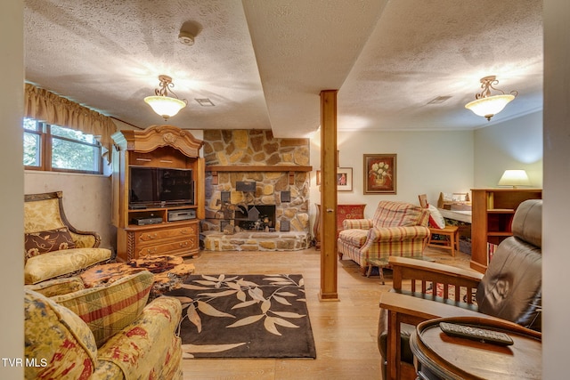 1049 Cooks Valley Rd, Kingsport, TN 37664 - living room with wood finished floors, a textured ceiling, and a fireplace