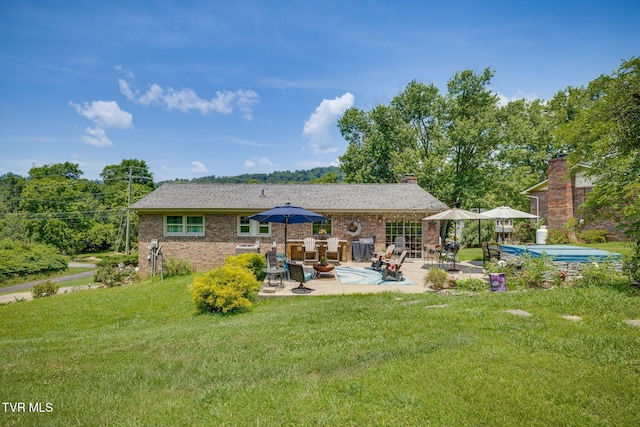 1049 Cooks Valley Rd, Kingsport, TN 37664 - rear view of property with a patio area, a yard, and brick siding