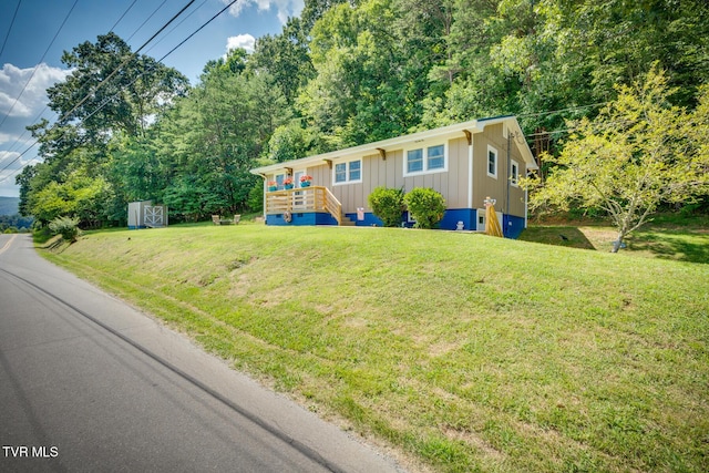 210 Anderson Rd, Johnson City, TN 37601 - ranch-style home with board and batten siding, a front yard, and a storage unit
