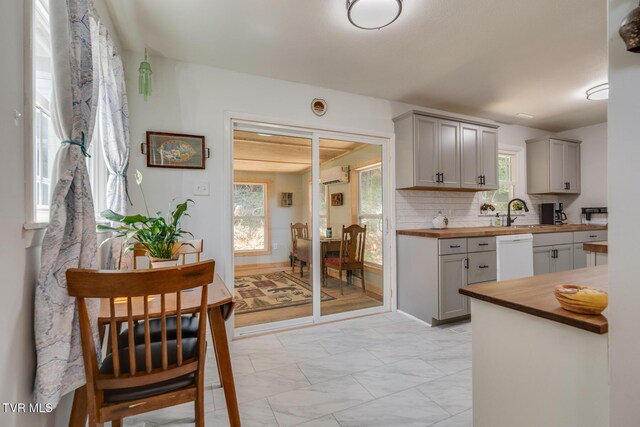 210 Anderson Rd, Johnson City, TN 37601 - kitchen featuring butcher block countertops, gray cabinets, dishwasher, light marble finish floors, and an AC wall unit