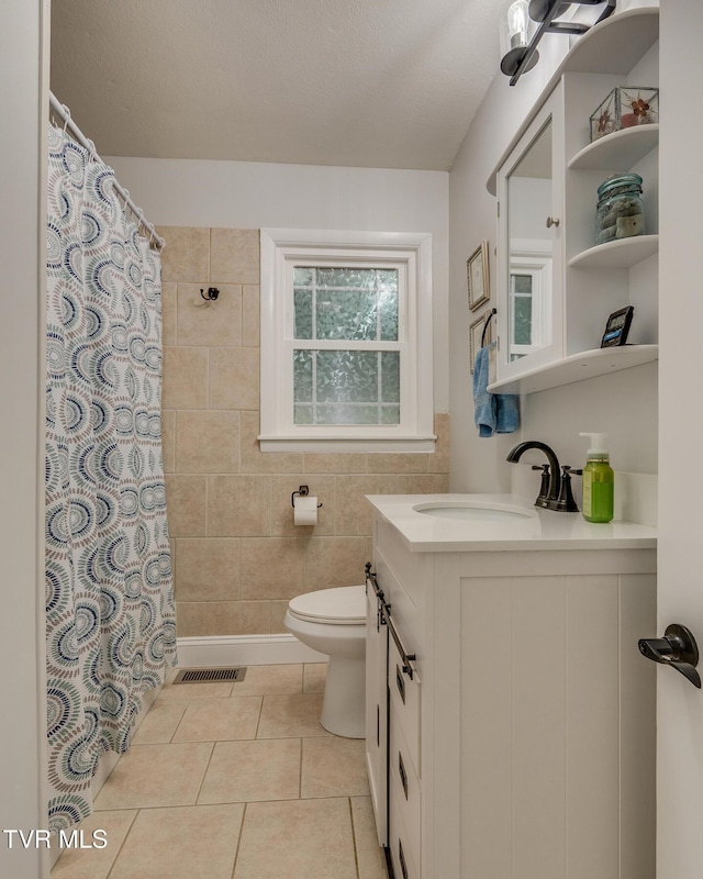 210 Anderson Rd, Johnson City, TN 37601 - full bath featuring vanity, tile walls, tile patterned flooring, and a shower with curtain