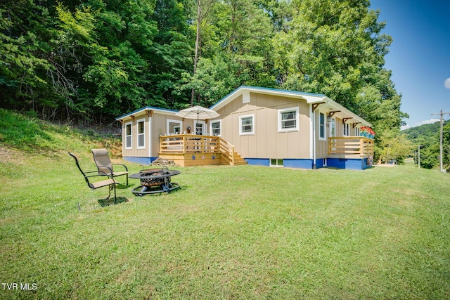 210 Anderson Rd, Johnson City, TN 37601 - rear view of house with a fire pit, a wooden deck, a yard, and board and batten siding
