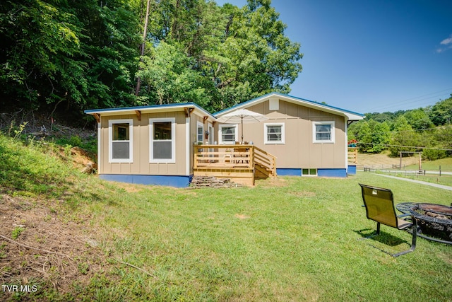 210 Anderson Rd, Johnson City, TN 37601 - back of house with a fire pit, board and batten siding, a deck, and an outdoor structure
