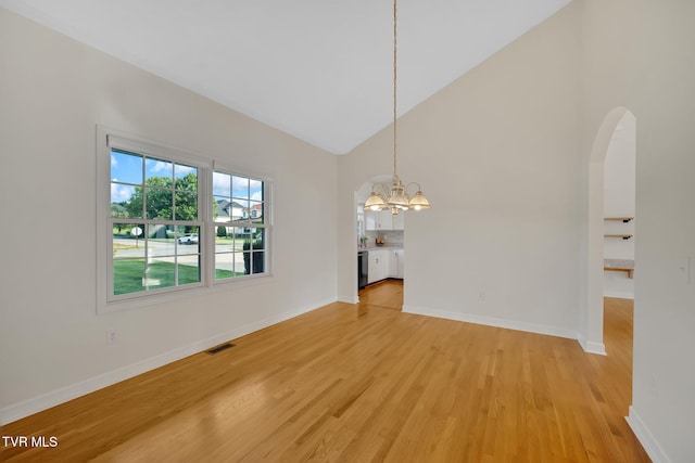 114 Wiltshire Dr, Gray, TN 37615 - unfurnished dining area featuring high vaulted ceiling, a chandelier, light wood-style floors, and arched walkways