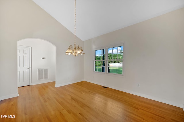 114 Wiltshire Dr, Gray, TN 37615 - empty room featuring a chandelier, arched walkways, high vaulted ceiling, and light wood-type flooring