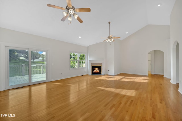 114 Wiltshire Dr, Gray, TN 37615 - unfurnished living room featuring a ceiling fan, arched walkways, high vaulted ceiling, a fireplace with flush hearth, and light wood-style flooring