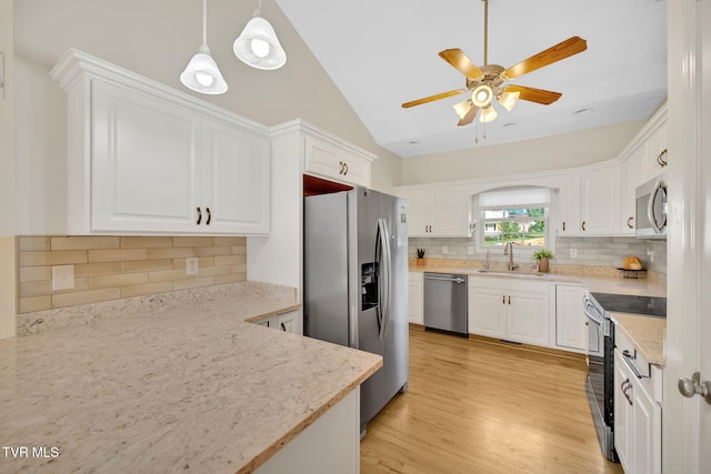 114 Wiltshire Dr, Gray, TN 37615 - kitchen with stainless steel appliances, ceiling fan, vaulted ceiling, white cabinets, and decorative backsplash