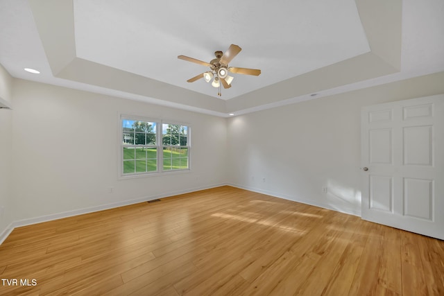 114 Wiltshire Dr, Gray, TN 37615 - empty room featuring a raised ceiling, a ceiling fan, and light wood finished floors
