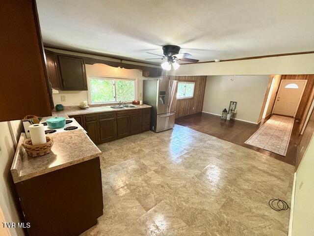 3219 Hardy Hollow Rd, Saint Paul, VA 24283 - kitchen with stainless steel refrigerator with ice dispenser, a ceiling fan, light countertops, dark brown cabinets, and light flooring