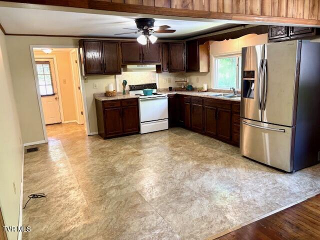 3219 Hardy Hollow Rd, Saint Paul, VA 24283 - kitchen featuring stainless steel refrigerator with ice dispenser, electric stove, under cabinet range hood, a ceiling fan, and plenty of natural light