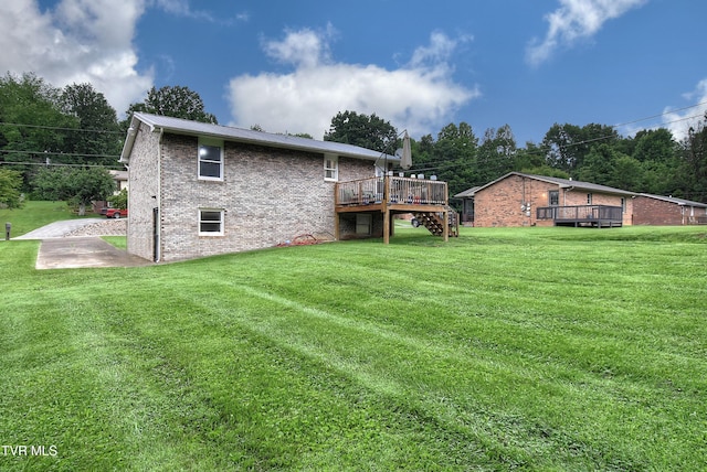 220 Tallman Dr, Blountville, TN 37617 - back of house with a deck, brick siding, a lawn, and a metal roof