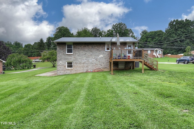 220 Tallman Dr, Blountville, TN 37617 - back of property featuring a deck, stairway, brick siding, a yard, and a metal roof
