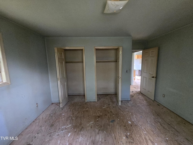 5875 Blue Springs Pkwy, Mosheim, TN 37818 - unfurnished bedroom with multiple closets and wood finished floors