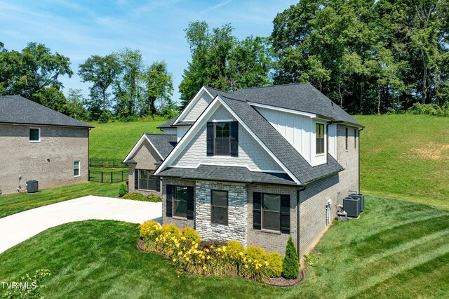 187 Tanners Cv, Johnson City, TN 37615 - view of front of house featuring board and batten siding, stone siding, roof with shingles, and a patio