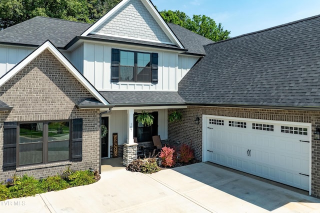 187 Tanners Cv, Johnson City, TN 37615 - view of front of house with board and batten siding, a porch, a garage, and a shingled roof