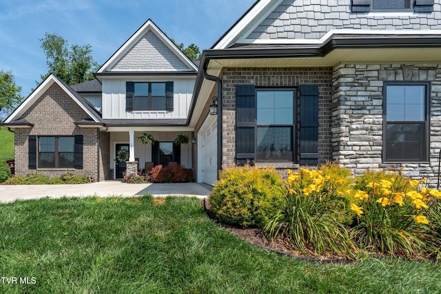 187 Tanners Cv, Johnson City, TN 37615 - view of front of house featuring board and batten siding, stone siding, and a front yard