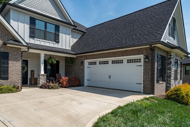 187 Tanners Cv, Johnson City, TN 37615 - view of property exterior featuring board and batten siding, brick siding, concrete driveway, and a porch