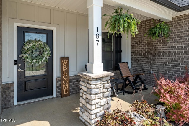 187 Tanners Cv, Johnson City, TN 37615 - entrance to property with covered porch, board and batten siding, and brick siding