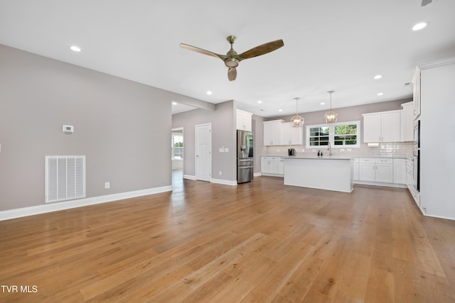 187 Tanners Cv, Johnson City, TN 37615 - unfurnished living room with a ceiling fan, light wood finished floors, and recessed lighting
