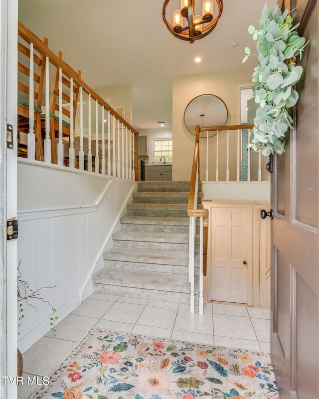 1136 W Shipley Ferry Rd, Kingsport, TN 37663 - stairway with tile patterned floors, a chandelier, recessed lighting, a decorative wall, and wainscoting