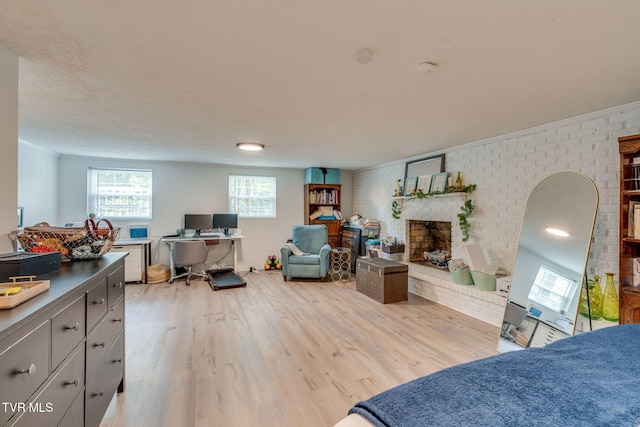 1136 W Shipley Ferry Rd, Kingsport, TN 37663 - bedroom featuring light wood finished floors, brick wall, an office area, and a brick fireplace