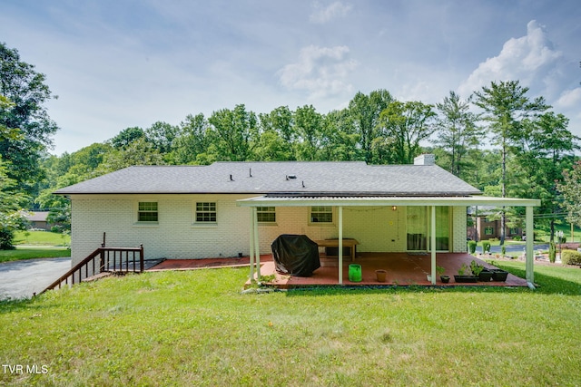 1136 W Shipley Ferry Rd, Kingsport, TN 37663 - rear view of house with brick siding, a patio, a yard, and a chimney