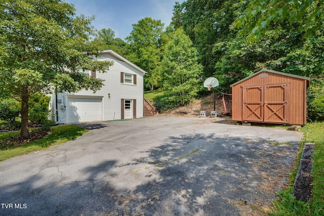 1136 W Shipley Ferry Rd, Kingsport, TN 37663 - view of home's exterior with a shed, asphalt driveway, stairs, and a garage