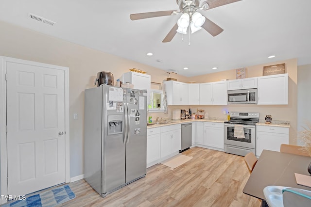 104 Kincheloe Rd, Fall Branch, TN 37656 - kitchen with stainless steel appliances, light wood-style floors, white cabinetry, light countertops, and a ceiling fan