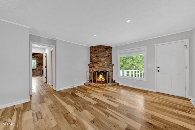 700 Sharon Dr, Johnson City, TN 37604 - unfurnished living room with a fireplace, light wood-style floors, crown molding, and recessed lighting