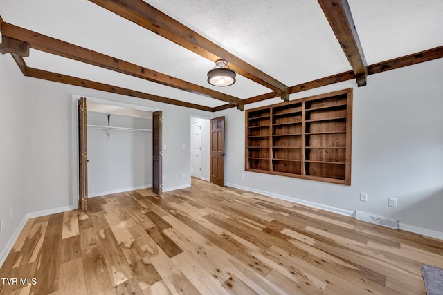 700 Sharon Dr, Johnson City, TN 37604 - unfurnished bedroom featuring beamed ceiling, light wood-type flooring, and a closet