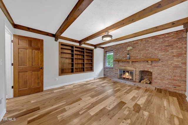 700 Sharon Dr, Johnson City, TN 37604 - unfurnished living room featuring wood finished floors, a fireplace, and beam ceiling