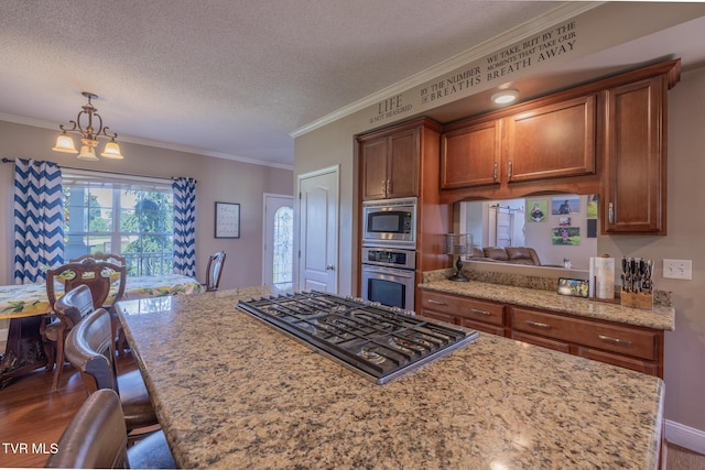 102 E Point Trce, Greeneville, TN 37745 - kitchen with appliances with stainless steel finishes, ornamental molding, a textured ceiling, dark wood-style flooring, and brown cabinetry