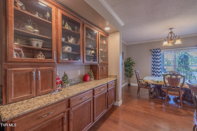 102 E Point Trce, Greeneville, TN 37745 - kitchen with a textured ceiling, dark wood-style floors, crown molding, a chandelier, and light stone counters