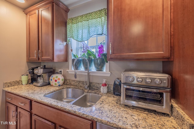 102 E Point Trce, Greeneville, TN 37745 - kitchen featuring light stone counters and brown cabinetry