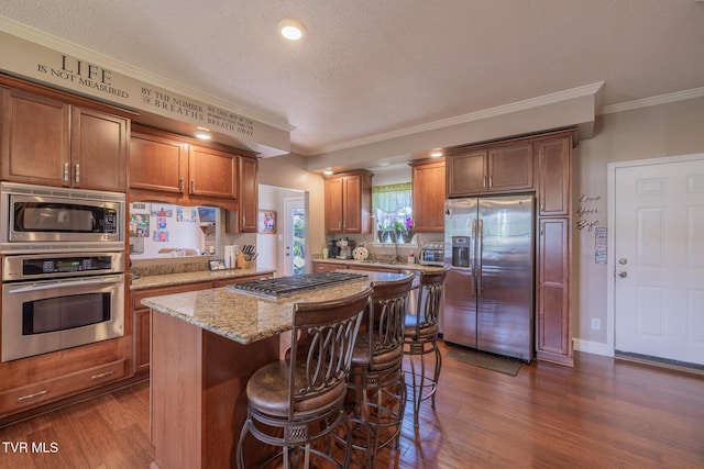 102 E Point Trce, Greeneville, TN 37745 - kitchen with stainless steel appliances, dark wood finished floors, a kitchen island, light stone countertops, and a textured ceiling