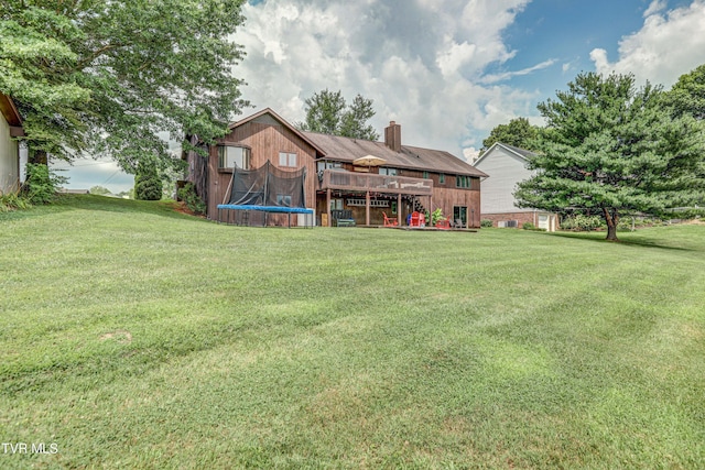 400 Heatherview Ct, Kingsport, TN 37663 - rear view of house with a chimney, a yard, a trampoline, and a wooden deck