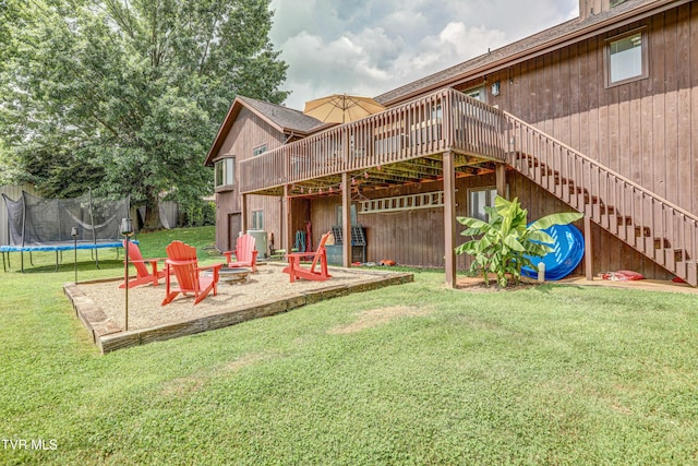 400 Heatherview Ct, Kingsport, TN 37663 - rear view of house with a wooden deck, stairs, a fire pit, a trampoline, and a lawn