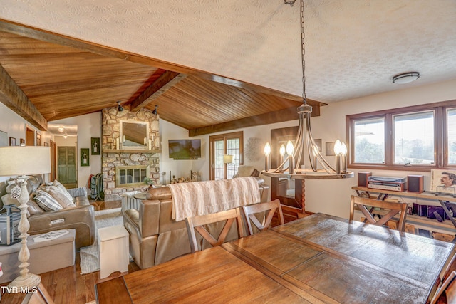 400 Heatherview Ct, Kingsport, TN 37663 - dining space with wood finished floors, a chandelier, plenty of natural light, a fireplace, and a textured ceiling