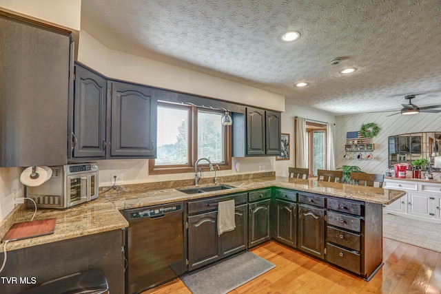 400 Heatherview Ct, Kingsport, TN 37663 - kitchen featuring black dishwasher, a peninsula, plenty of natural light, light wood-type flooring, and wood walls