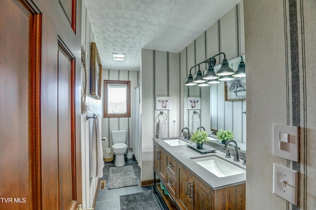 400 Heatherview Ct, Kingsport, TN 37663 - bathroom featuring a textured ceiling, double vanity, tile patterned floors, and a shower with shower curtain