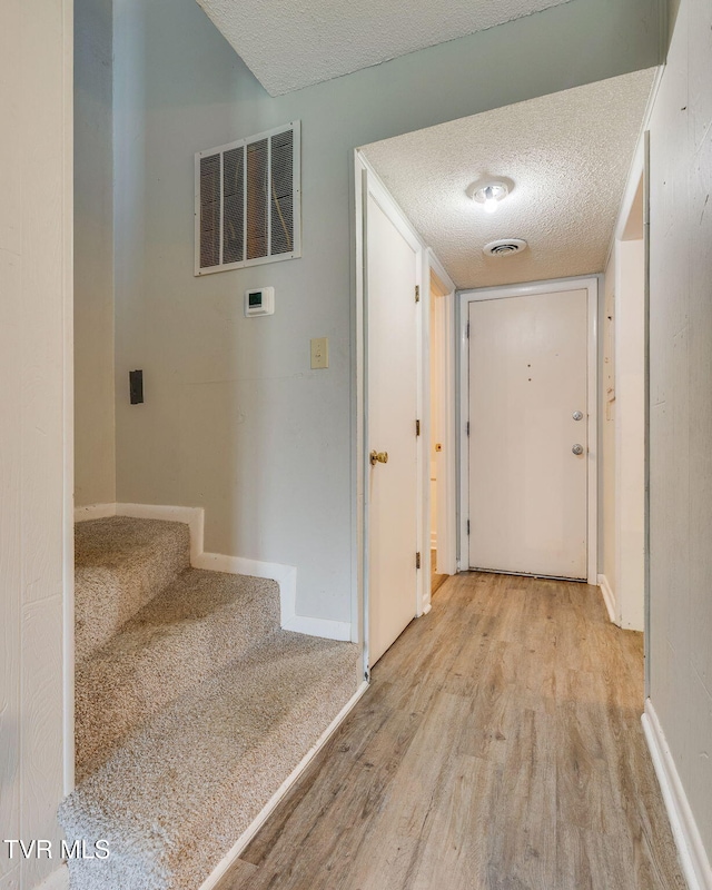 815 7th St Unit 815, Bristol, TN 37620 - corridor featuring wood finished floors, a textured ceiling, and stairs