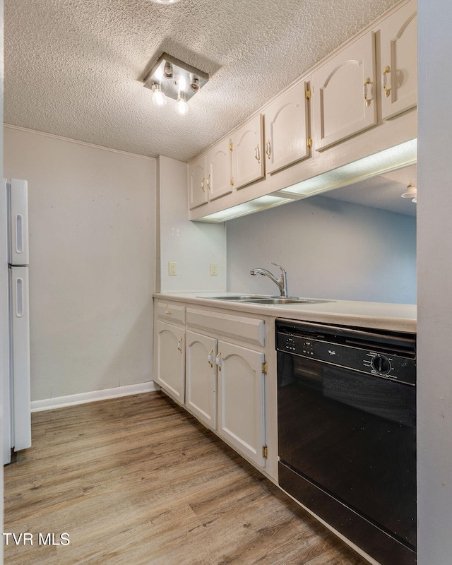 815 7th St Unit 815, Bristol, TN 37620 - kitchen with black dishwasher, light wood finished floors, a textured ceiling, white cabinets, and light countertops