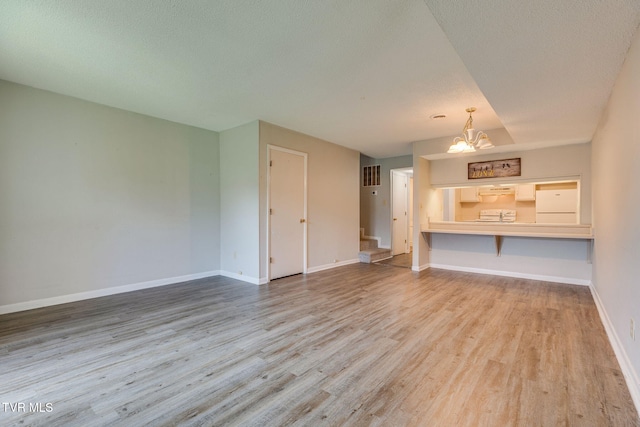 815 7th St Unit 815, Bristol, TN 37620 - unfurnished living room featuring wood finished floors, a chandelier, and stairs